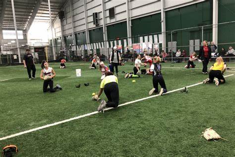 Competitive Edge girls training softball on field indoor